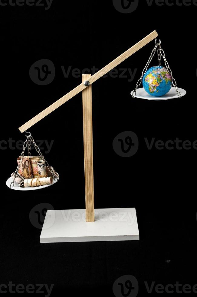Scales weighing objects on dark background photo