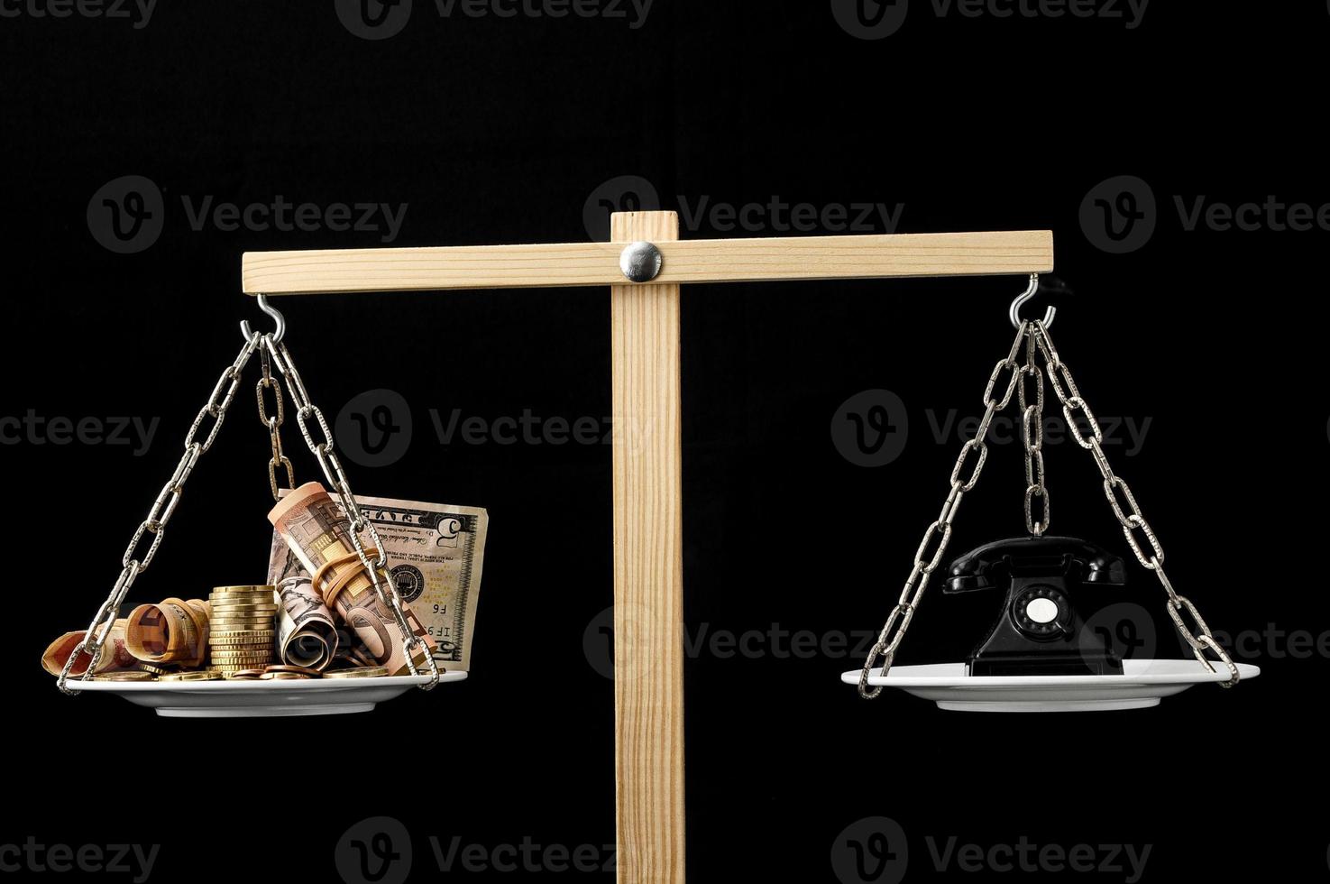 Scales weighing objects on dark background photo