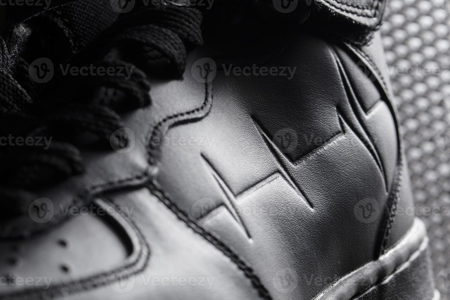 Fragment of a black boot macro photo