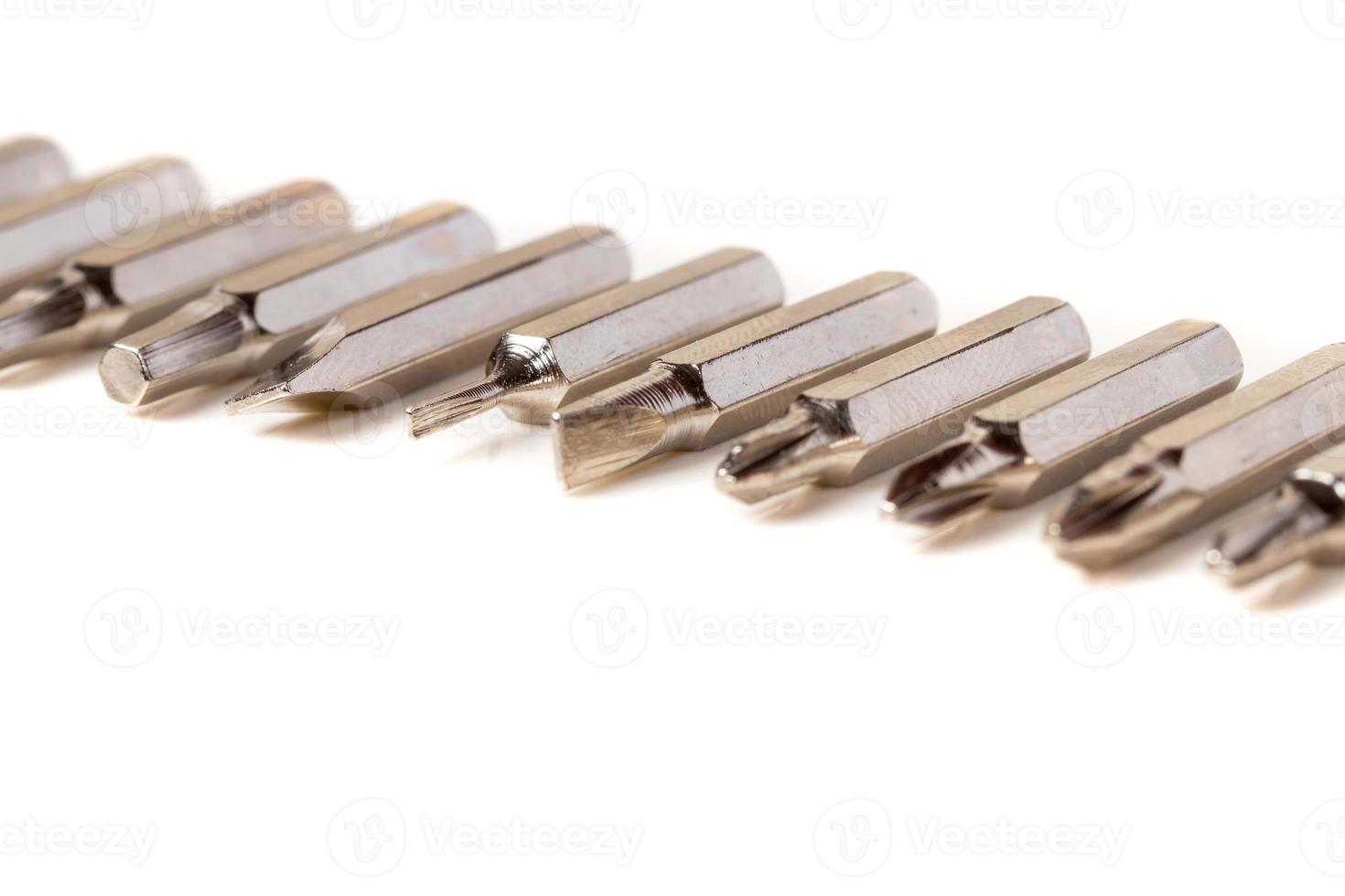 A set of different attachments for a head screwdriver with a screwdriver on a white background photo