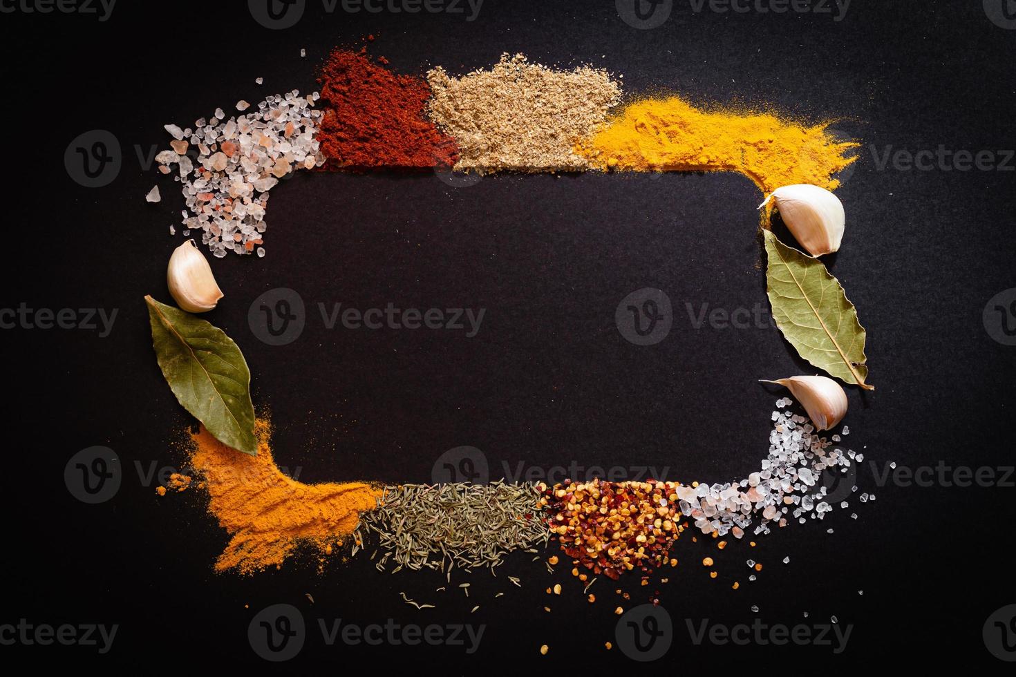 Set of Various spices on black stone table. Top view with copy space. photo