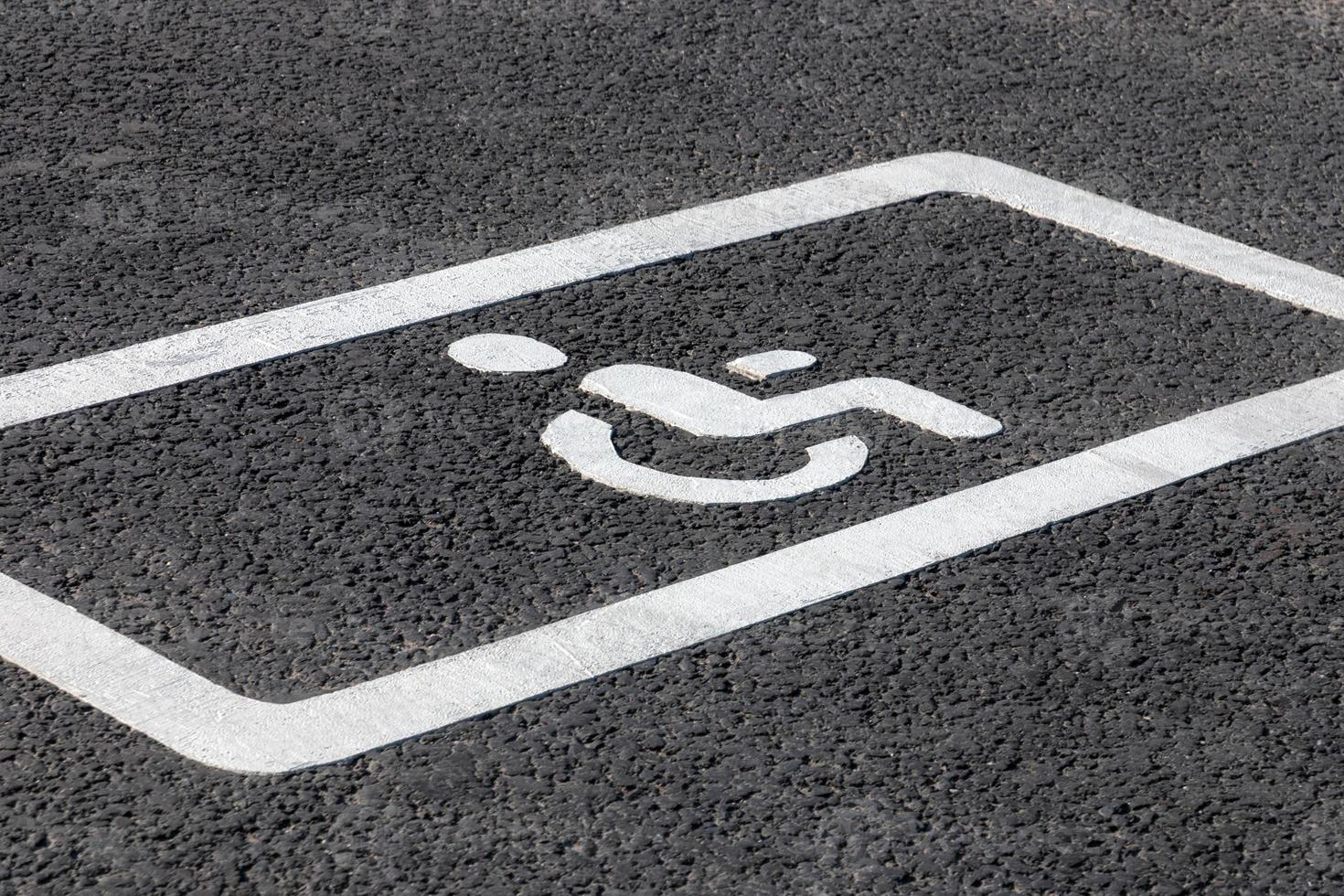 Parking spot for disabled drivers, road marking on asphalt road photo