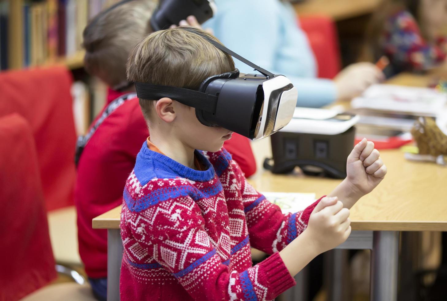 Child in virtual glasses. The boy in 3D glasses. photo