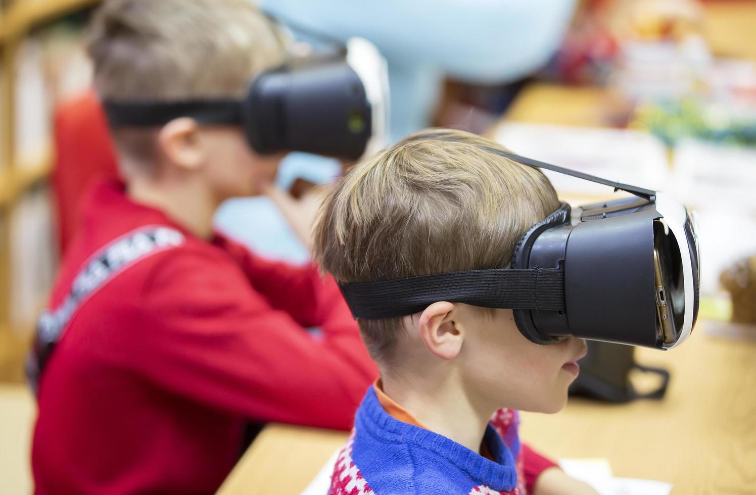 Children in virtual glasses. The boy in 3D glasses. photo