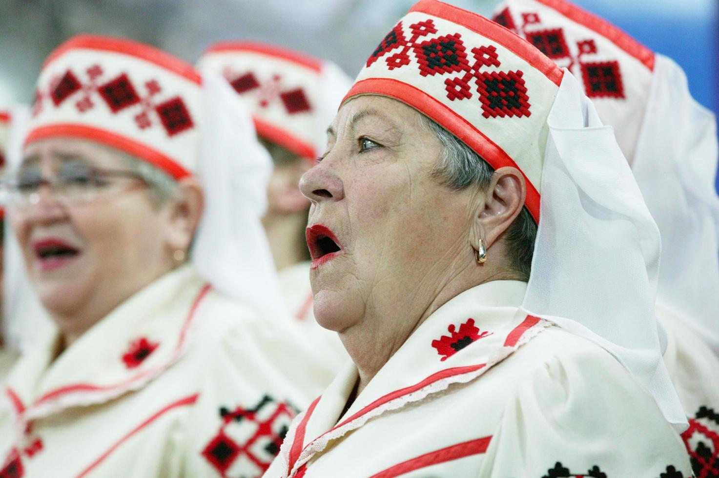 Belarus, the city of Gomil, November 12, 2018. House of retirees. Old Slavic women sing songs. Belarusian women in national hats. photo