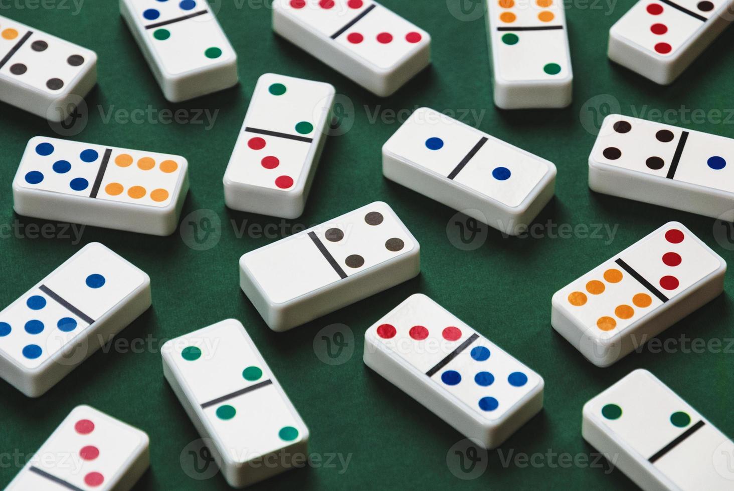 Domino tiles on green table, domino game background photo