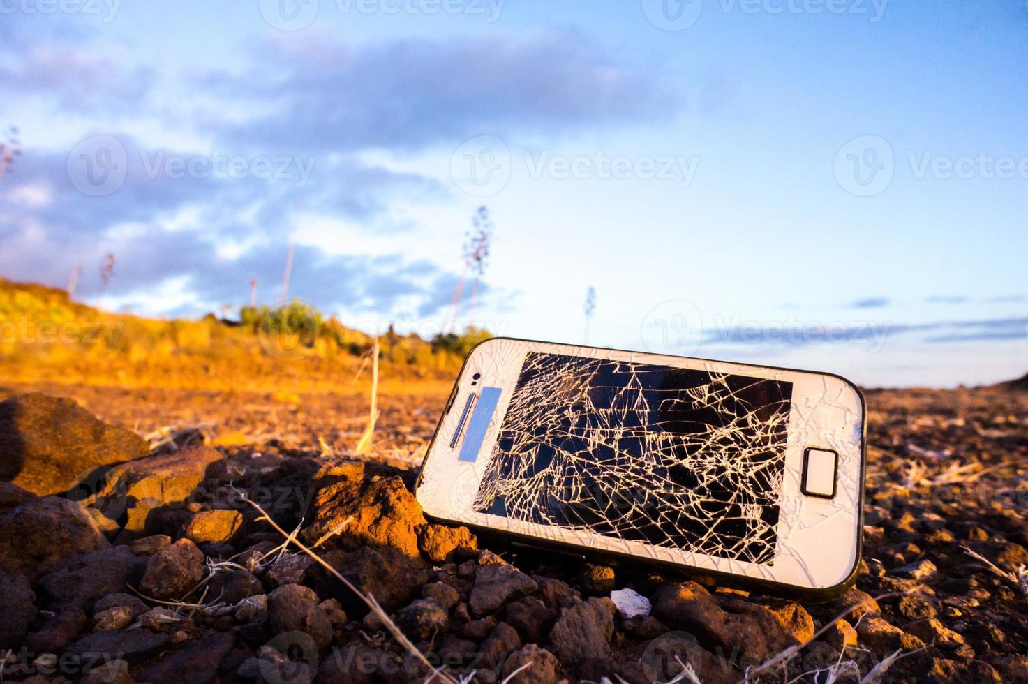 Broken phone on the ground photo