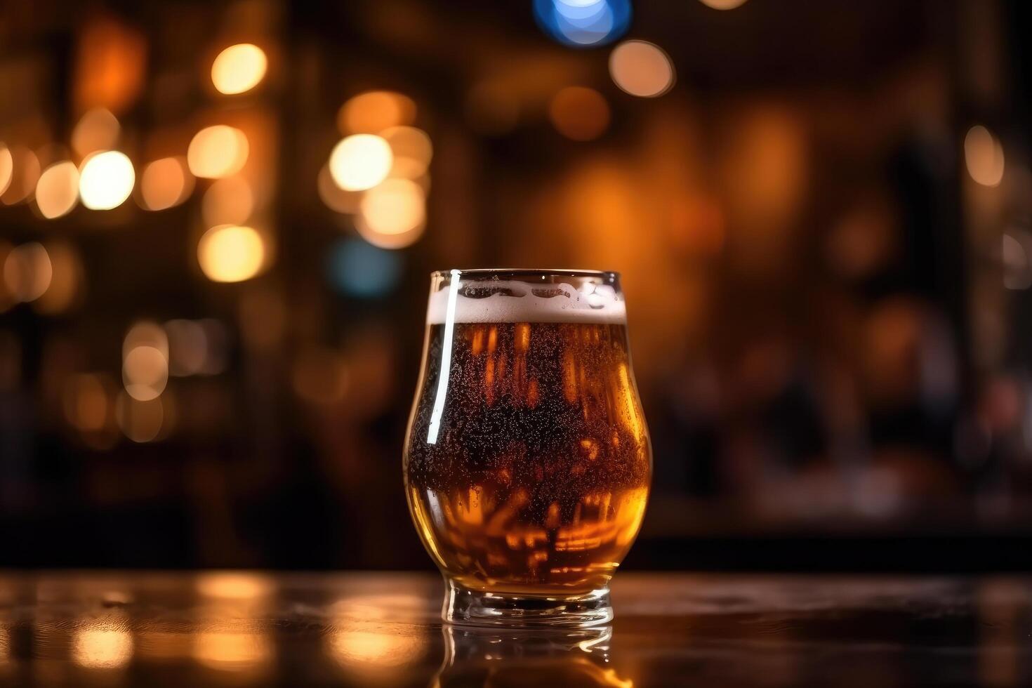 Glass of beer on a table in a bar on blurred bokeh background photo