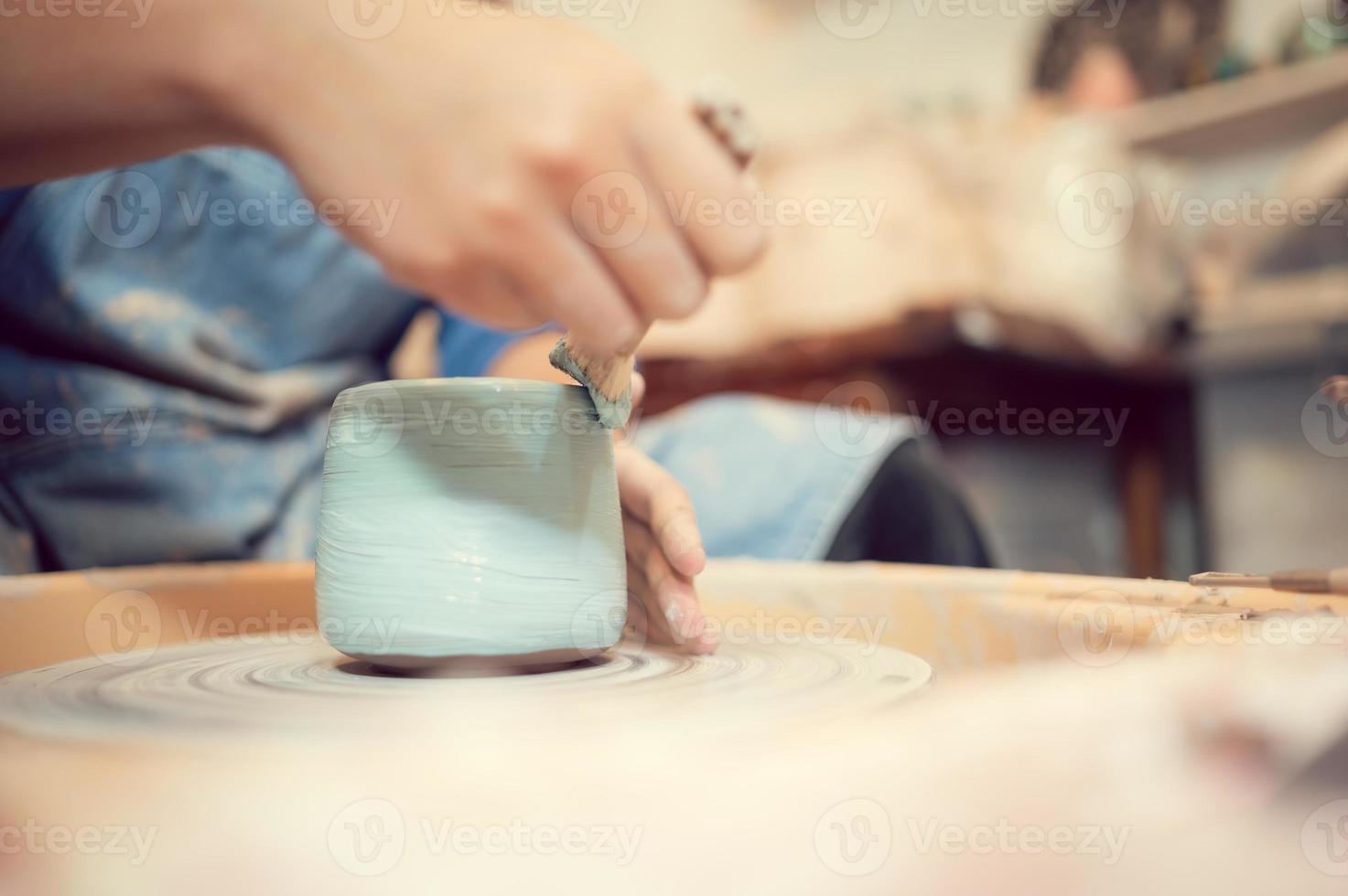 Painting the sculpture is one of the artist pottery processes. photo