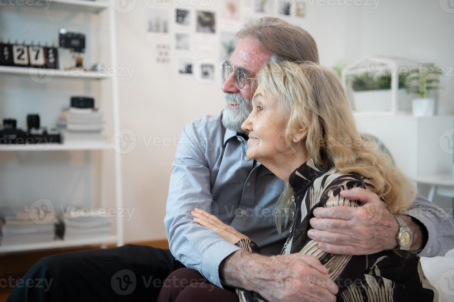 A long-term relationship that lasts till old age, characterized by unwavering affection. Still expressing affection and joyfully hugging one another. photo