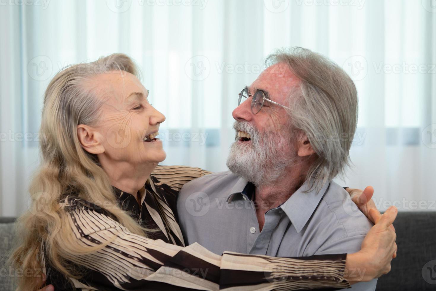 A long-term relationship that lasts till old age, characterized by unwavering affection. Still expressing affection and joyfully hugging one another. photo