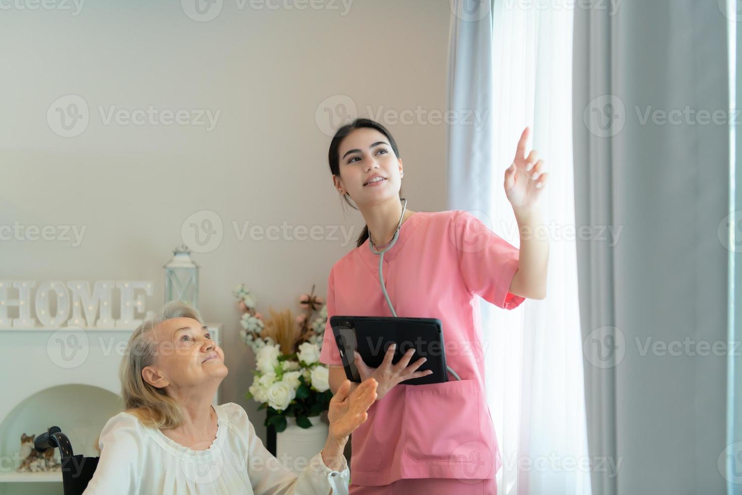 Caregiver for an elderly woman Weekly check-ups at the patient's residence. Ready to give medical advice and talk about various stories, exchange each other happily. photo