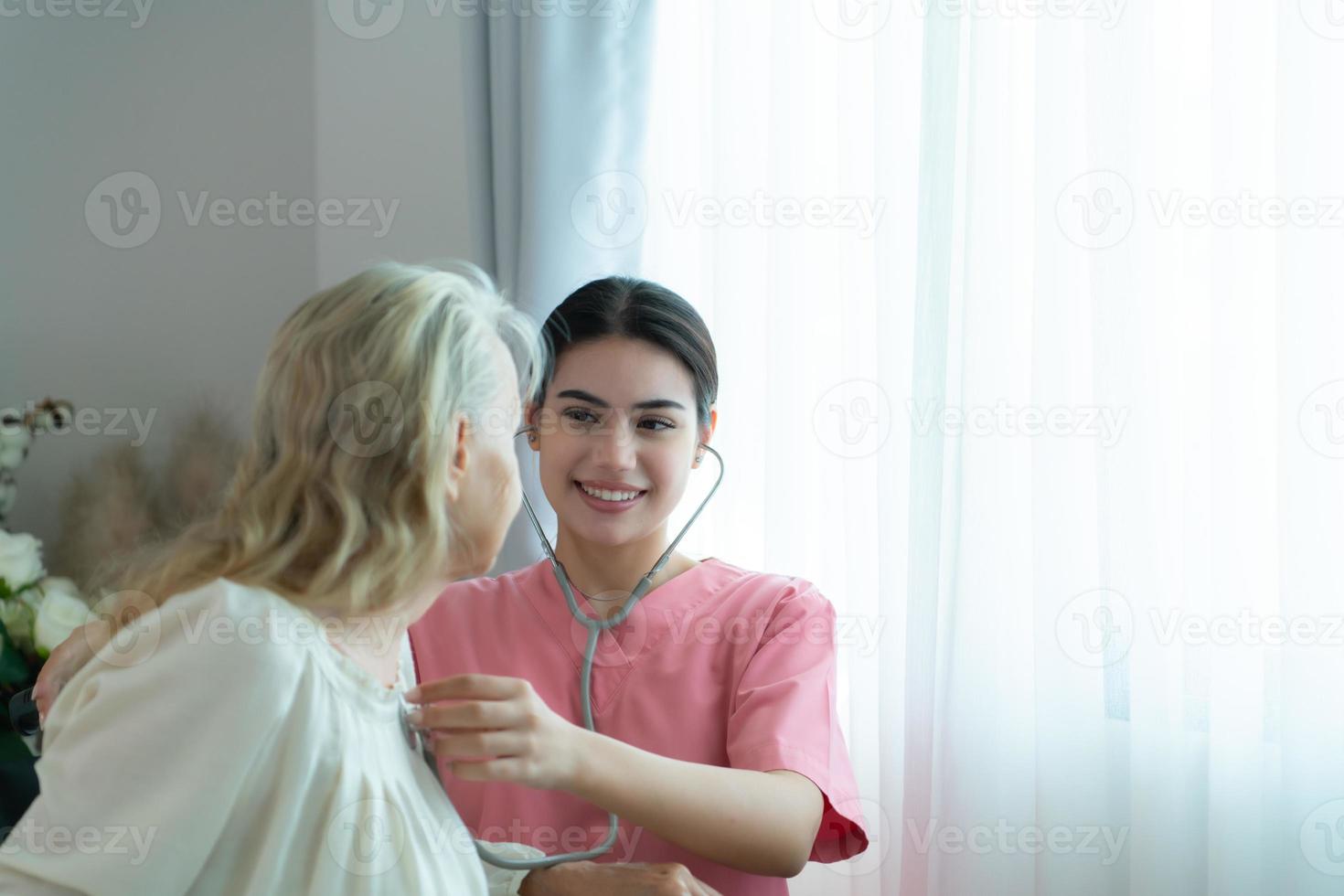 Caregiver for an elderly woman Weekly check-ups at the patient's residence. Ready to give medical advice and talk about various stories, exchange each other happily. photo