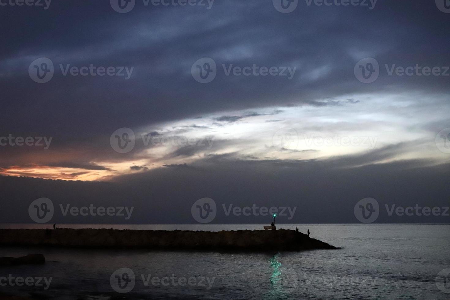 A lighthouse is a navigational landmark that is used to identify coasts and locate ships. photo