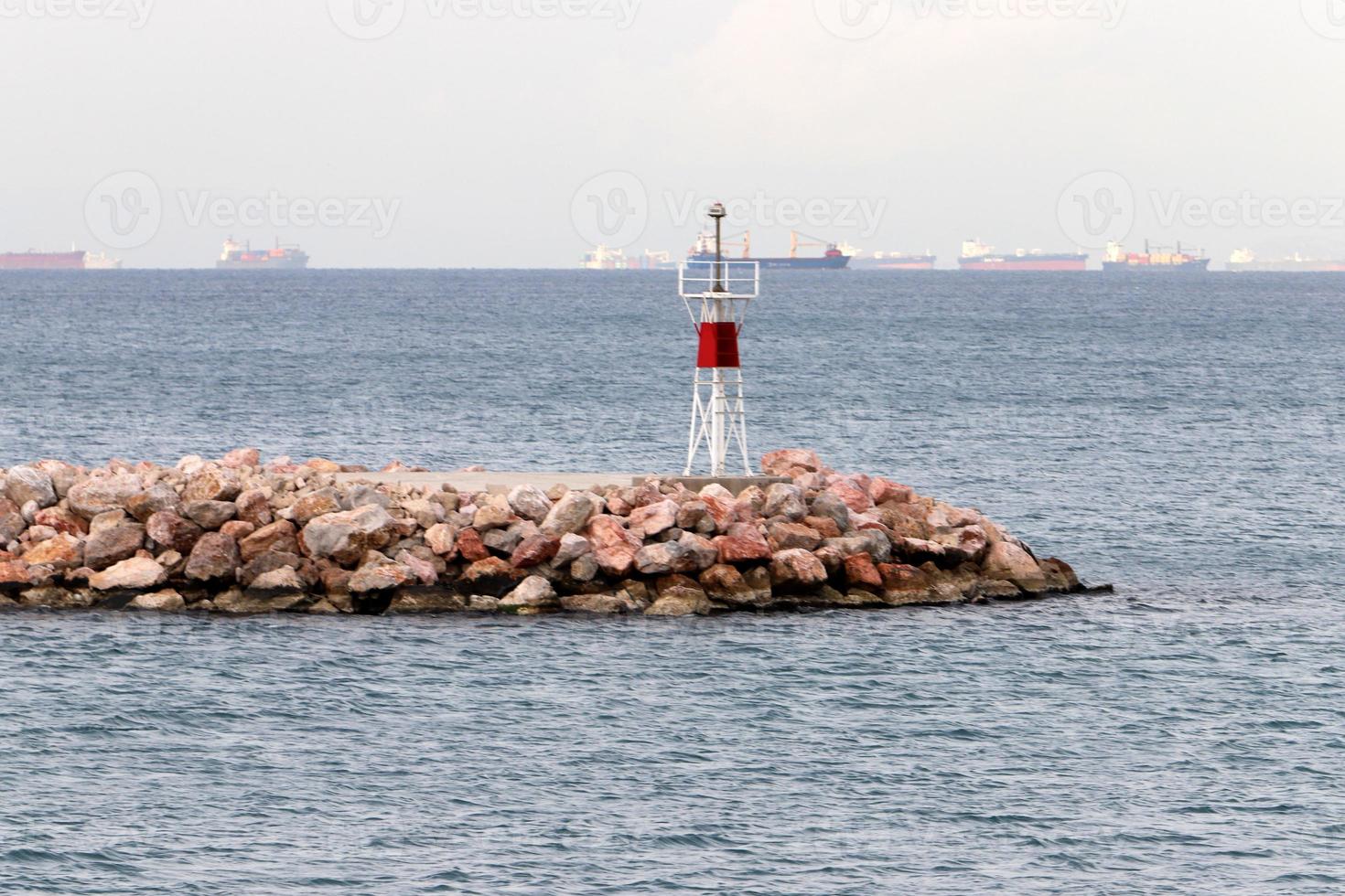 A lighthouse is a navigational landmark that is used to identify coasts and locate ships. photo