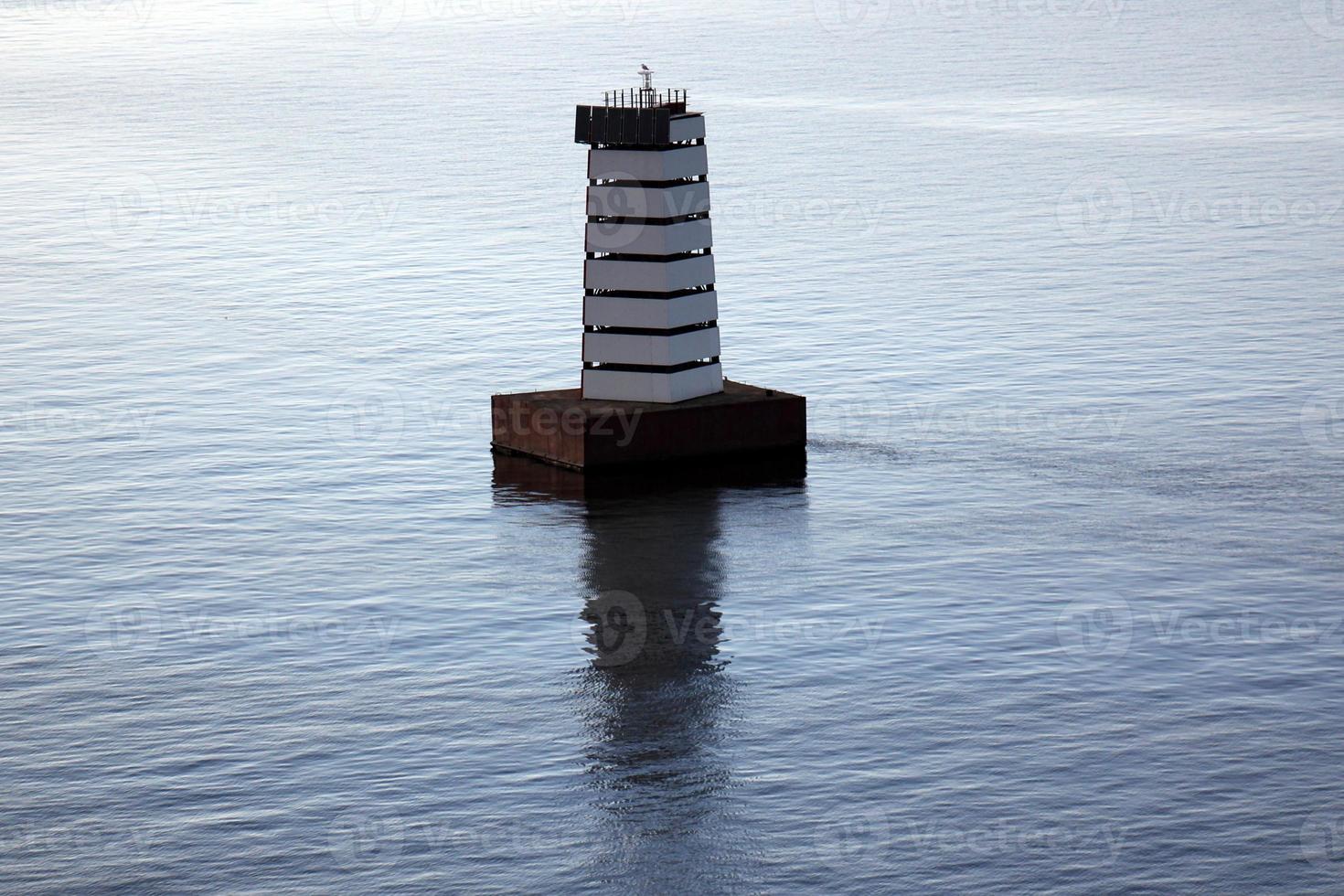 A lighthouse is a navigational landmark that is used to identify coasts and locate ships. photo