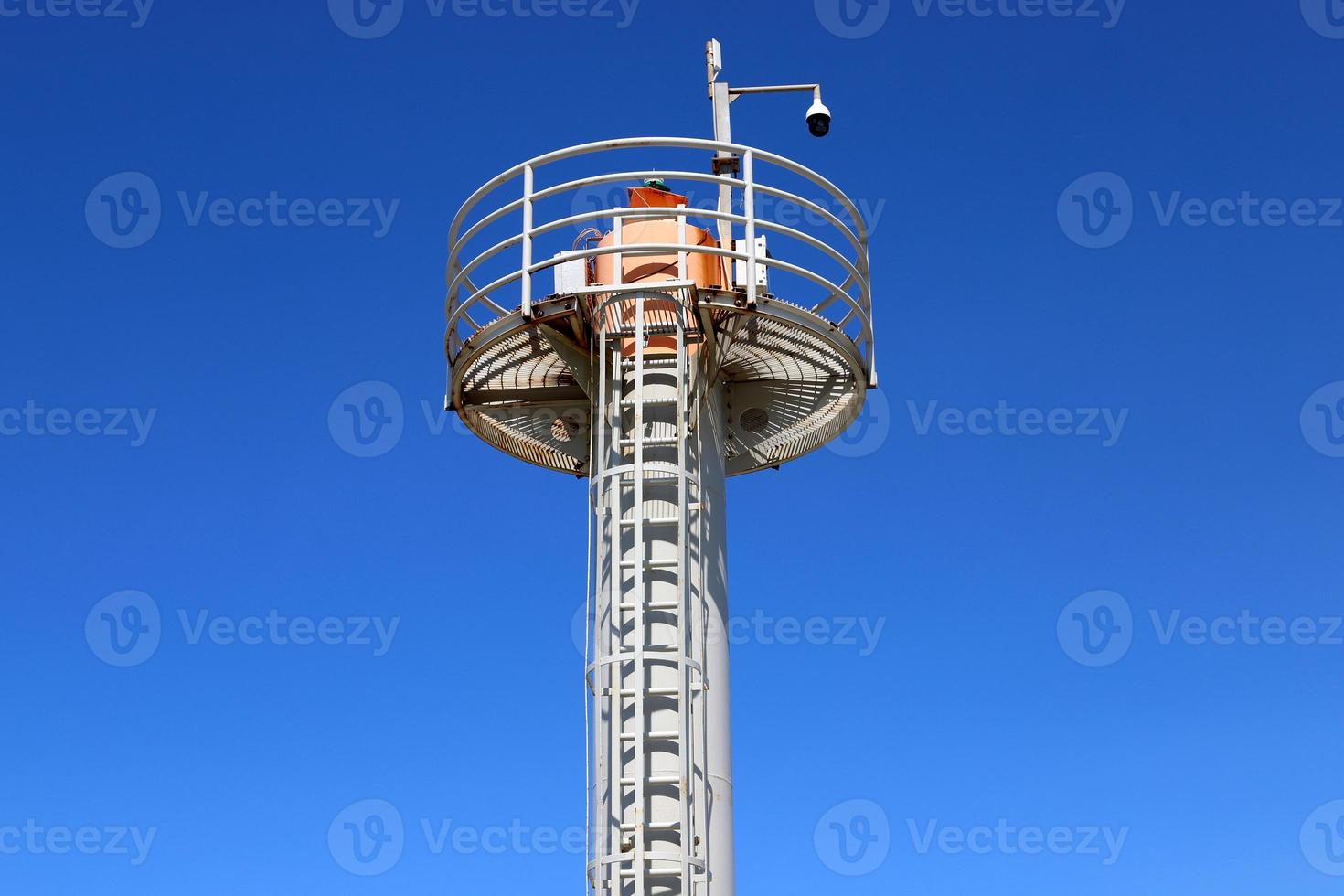 A lighthouse is a navigational landmark that is used to identify coasts and locate ships. photo