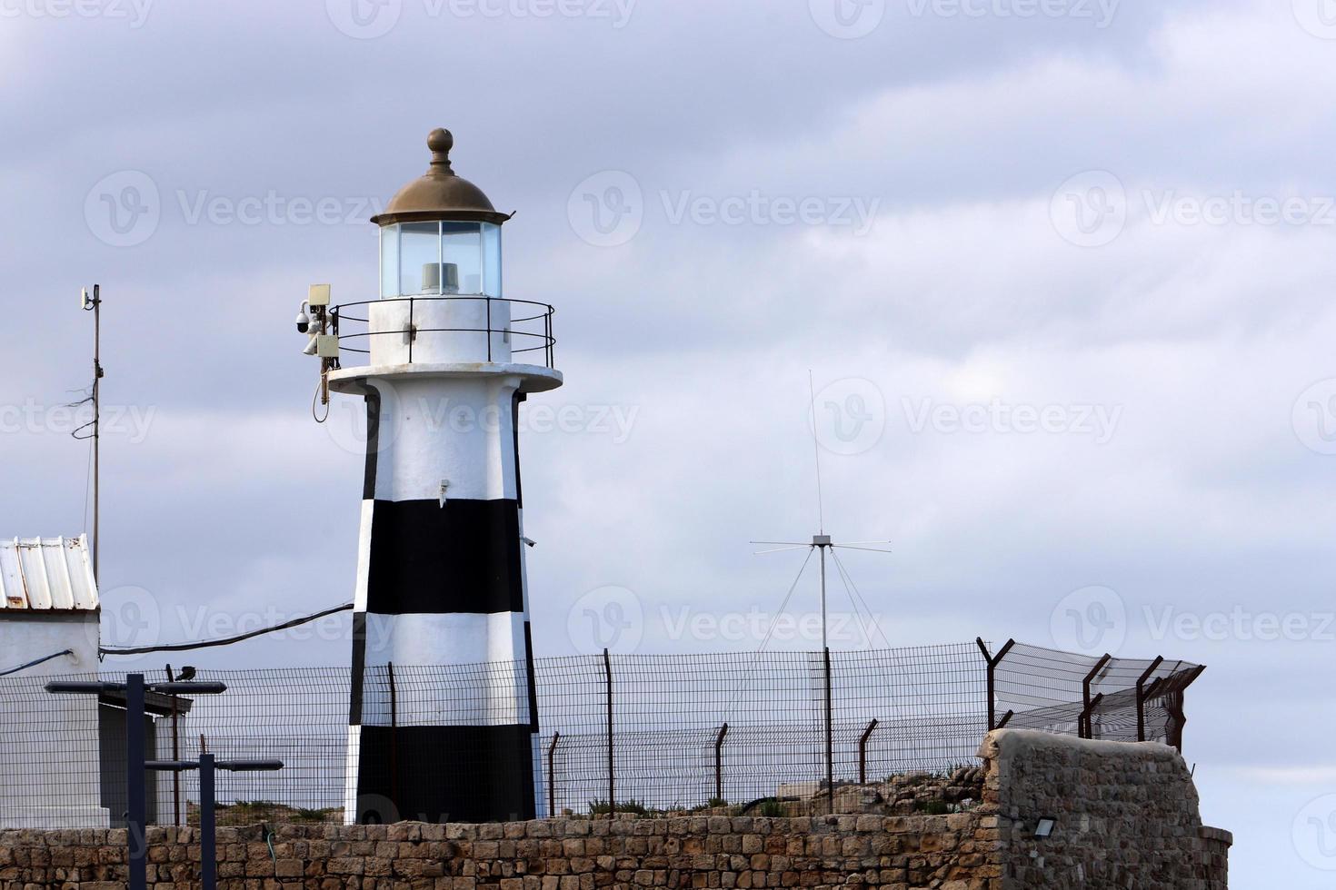 A lighthouse is a navigational landmark that is used to identify coasts and locate ships. photo