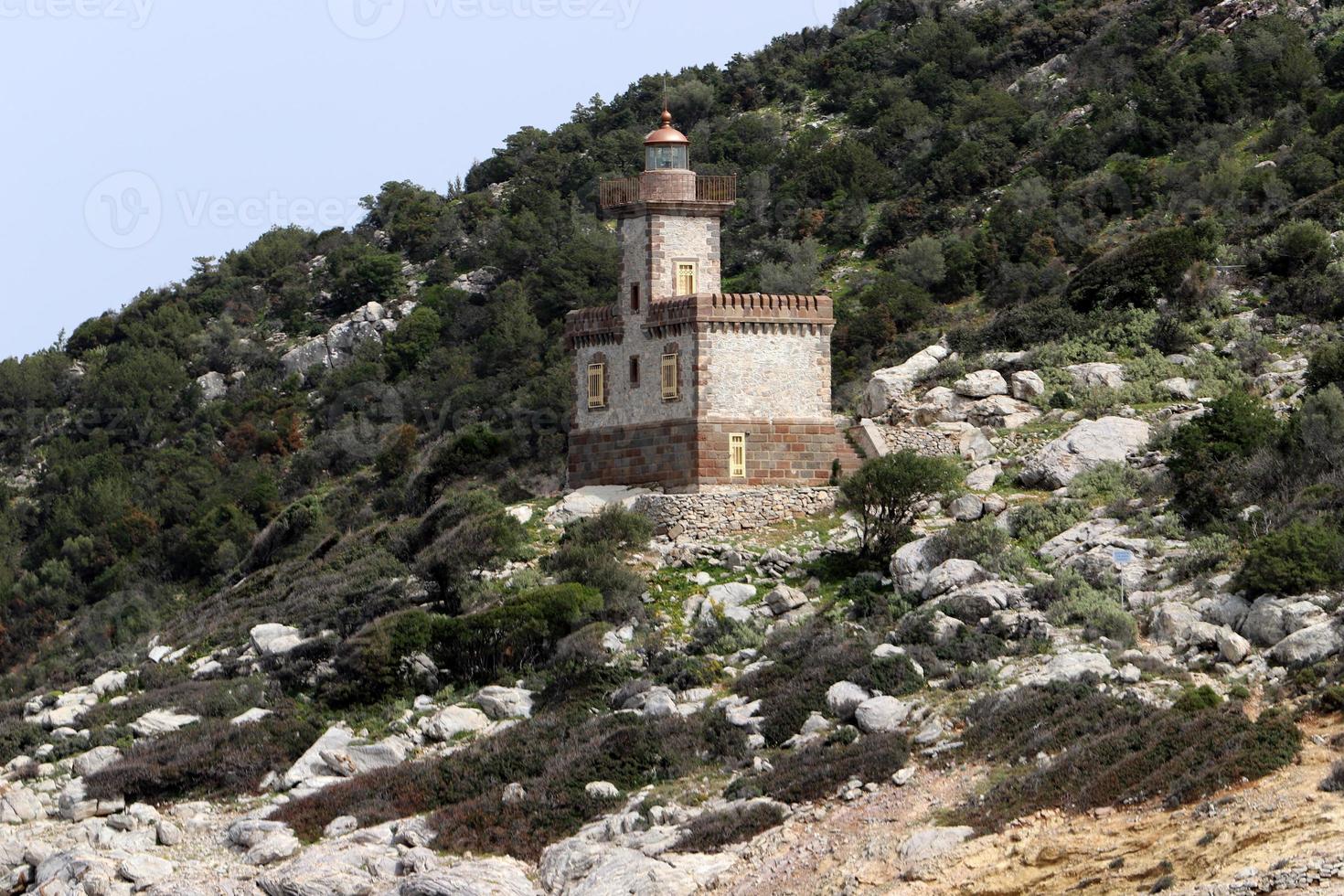 A lighthouse is a navigational landmark that is used to identify coasts and locate ships. photo