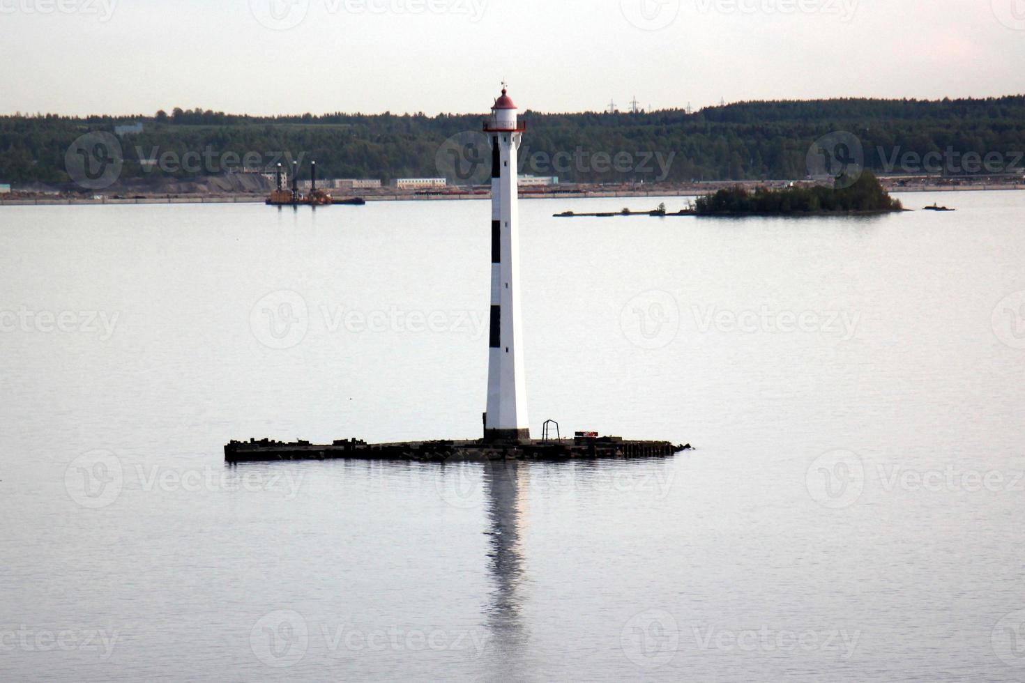 A lighthouse is a navigational landmark that is used to identify coasts and locate ships. photo