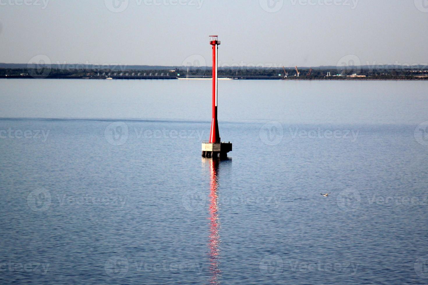 A lighthouse is a navigational landmark that is used to identify coasts and locate ships. photo