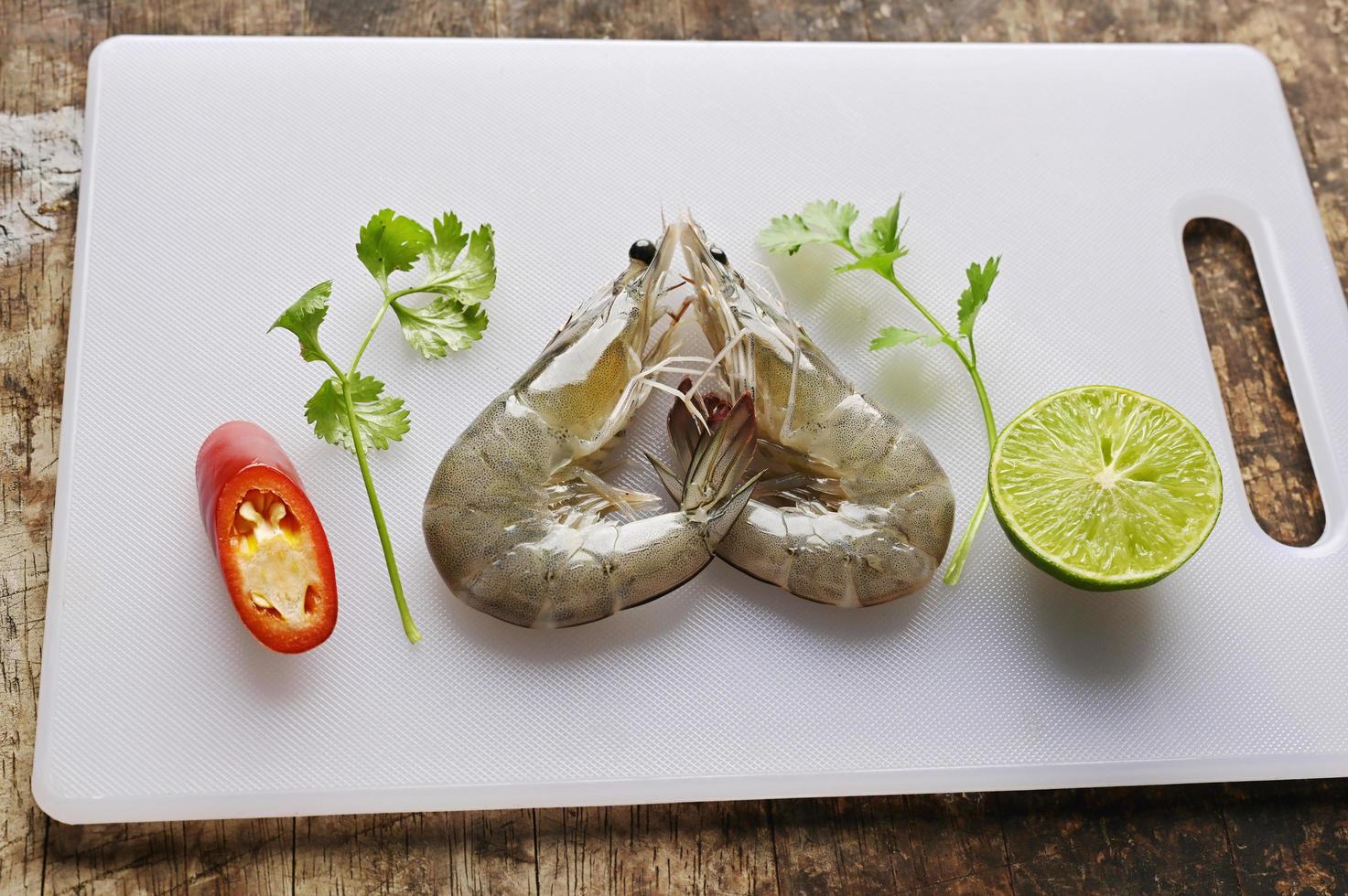fresh prawn or shrimp on butcher with vegetable photo