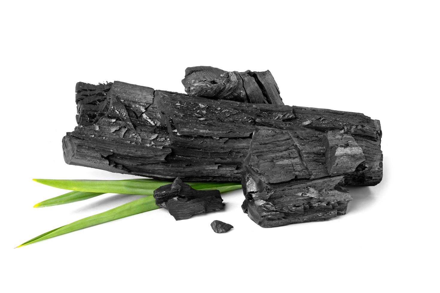 wood natural charcoal with pandan leaf isolate on white background photo