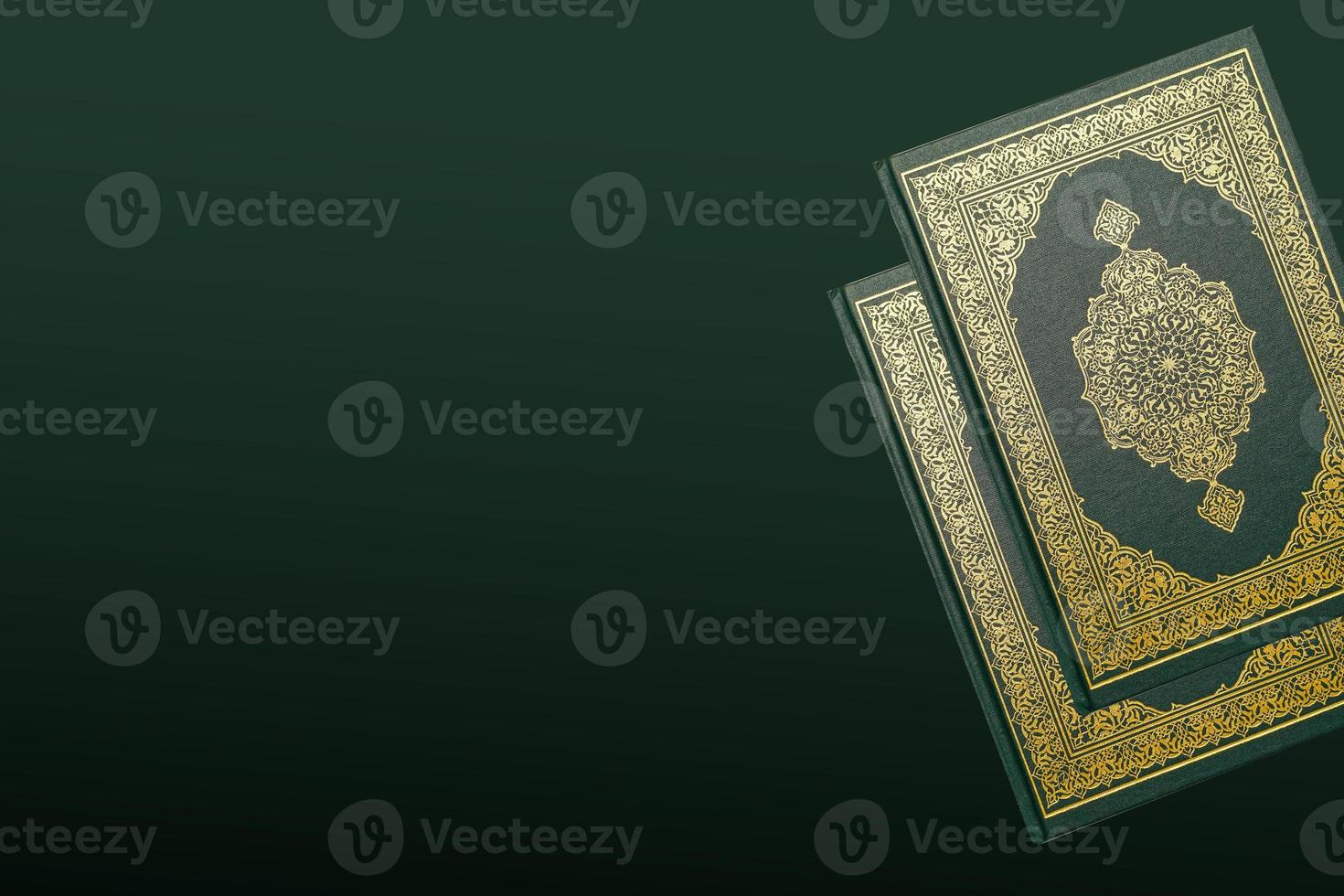 The Holy Al Quran with written arabic calligraphy meaning of Al Quran and rosary beads or tasbih on dark green black background with copy space. photo