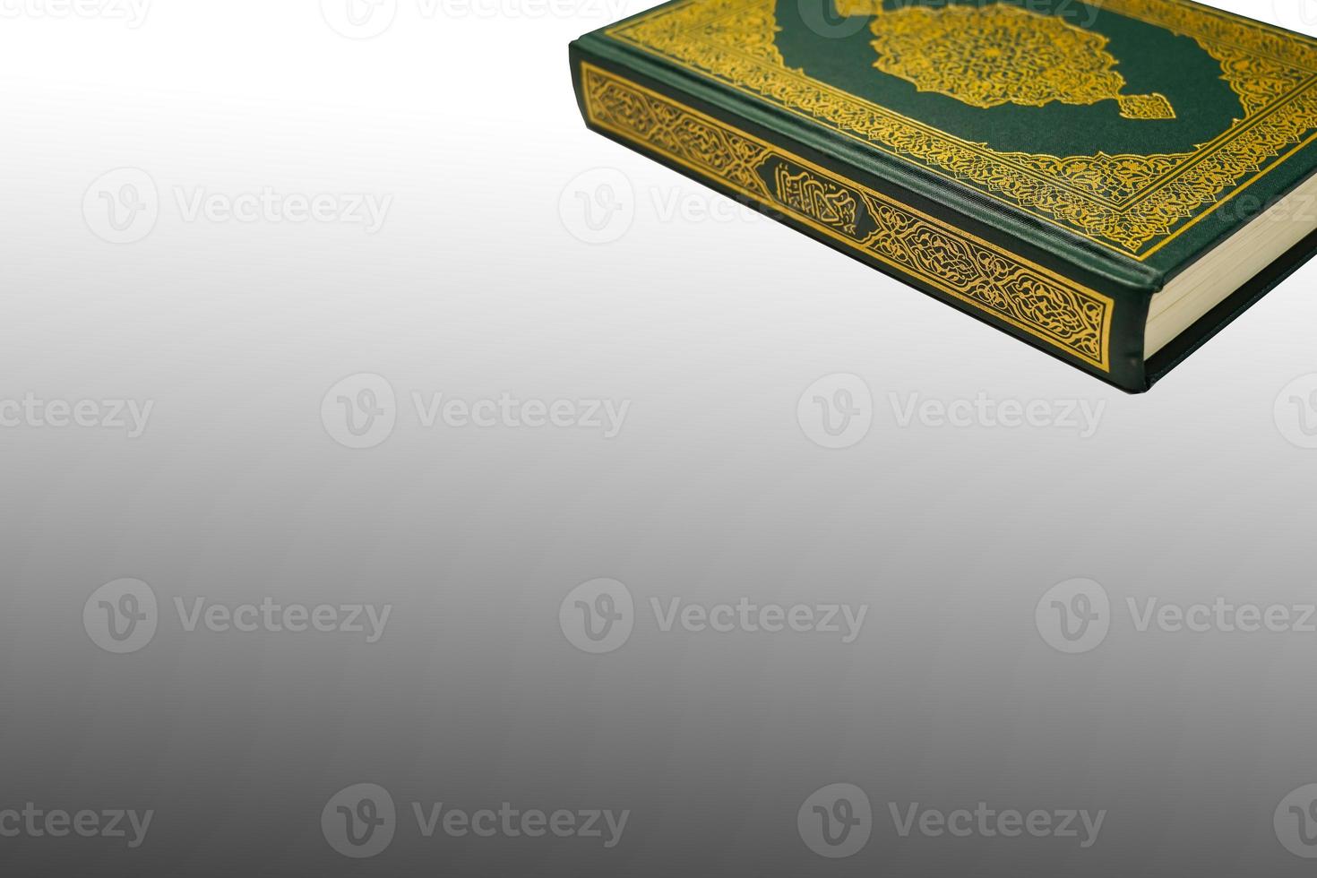 The Holy Al Quran with written arabic calligraphy meaning of Al Quran and rosary beads or tasbih on white background, isolated with copy space. photo