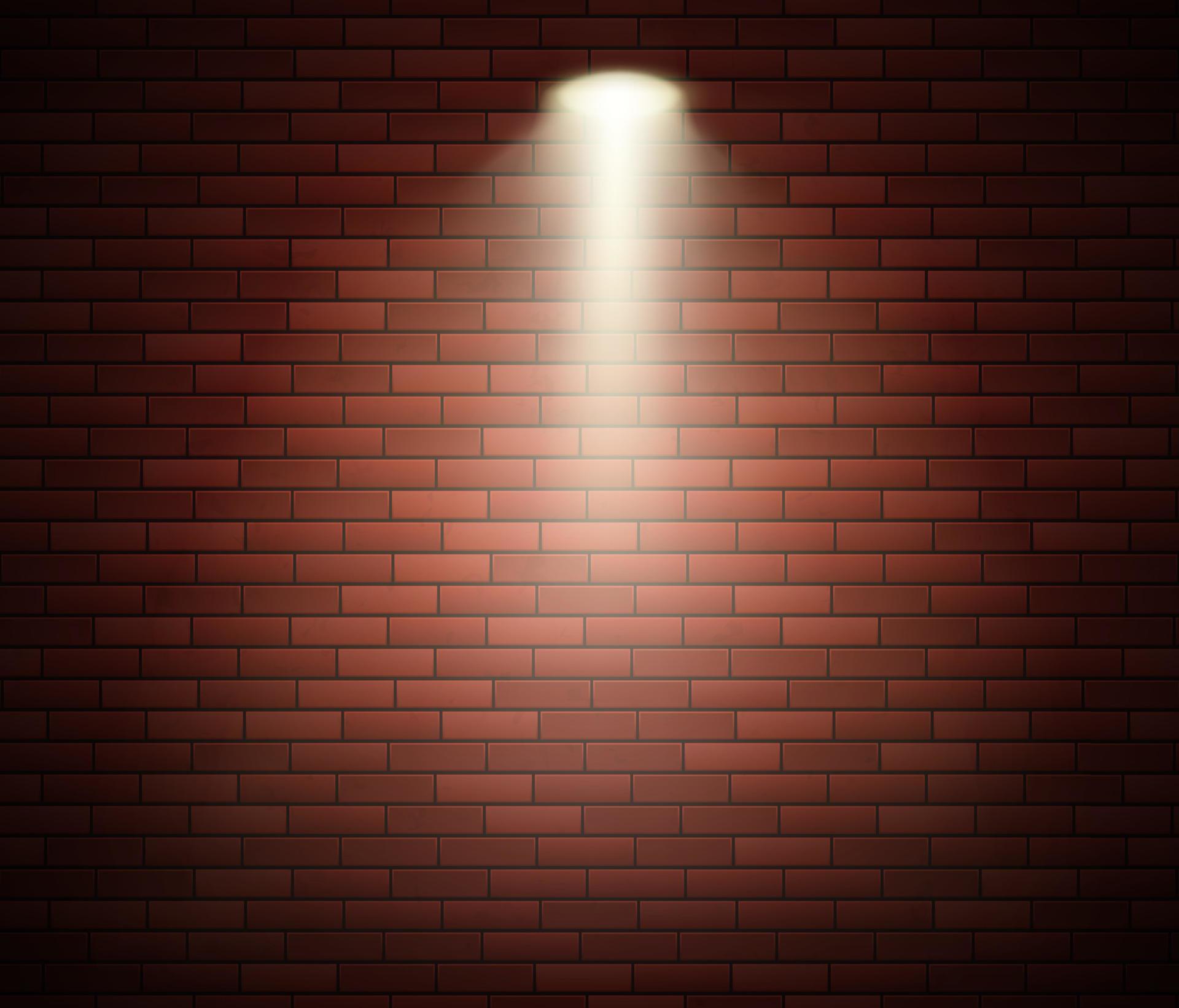 Spotlight against brick wall. Empty Studio decorated brick wall and