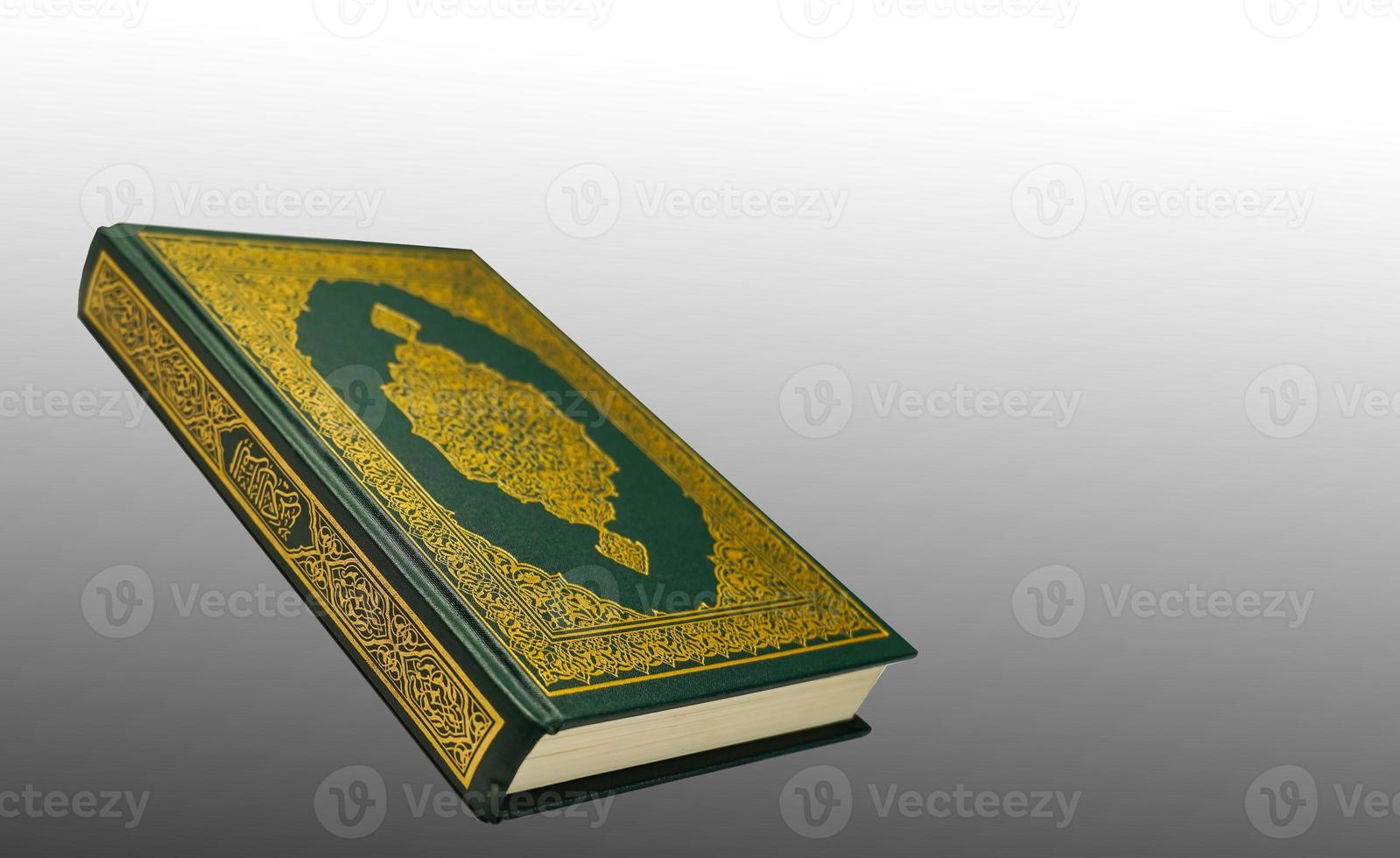 The Holy Al Quran with written arabic calligraphy meaning of Al Quran and rosary beads or tasbih on white background, isolated with copy space. photo