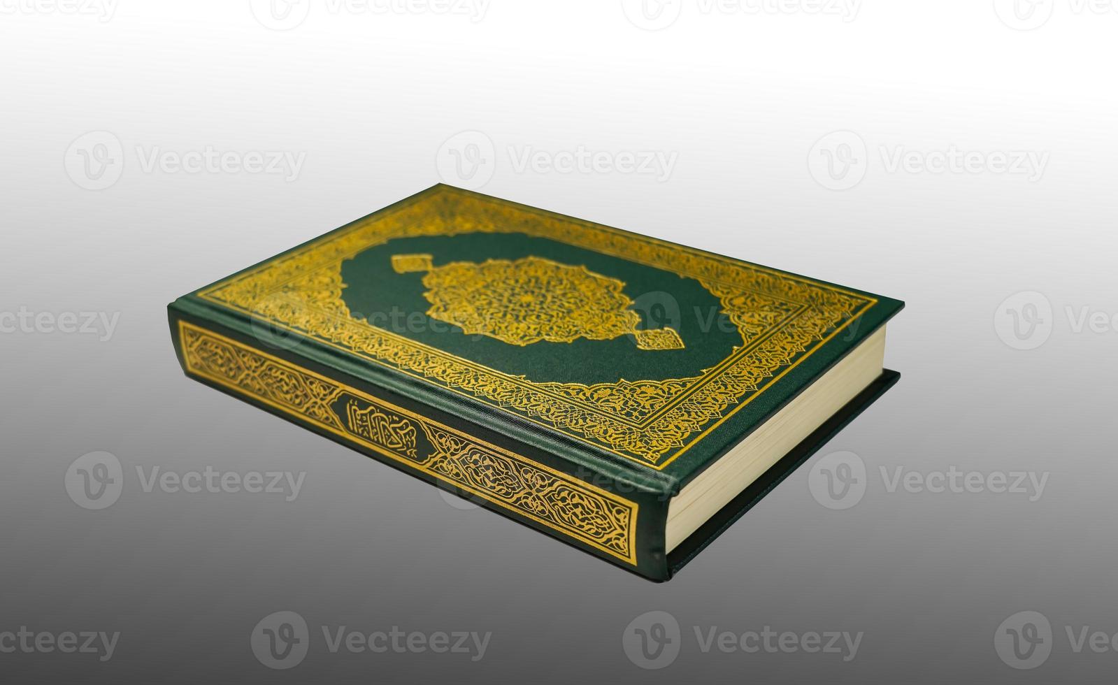 The Holy Al Quran with written arabic calligraphy meaning of Al Quran and rosary beads or tasbih on dark green black background with copy space. photo