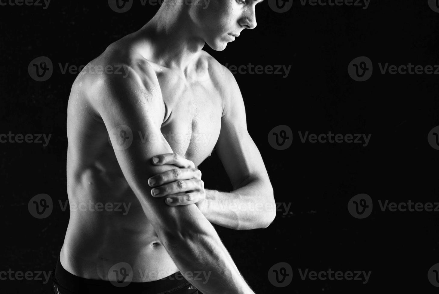 man with dumbbells in hands pumping up muscles exercises photo