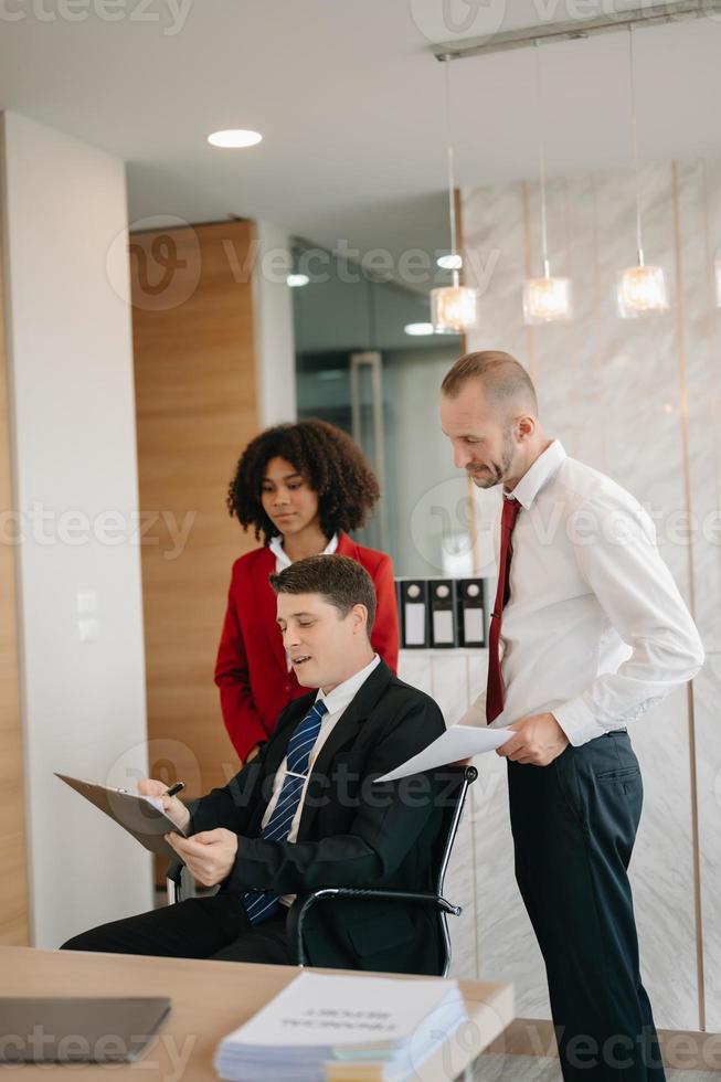 Office colleagues have a casual discussion. During a meeting in a conference room, a group of business teem sit in the conference room new startup project photo