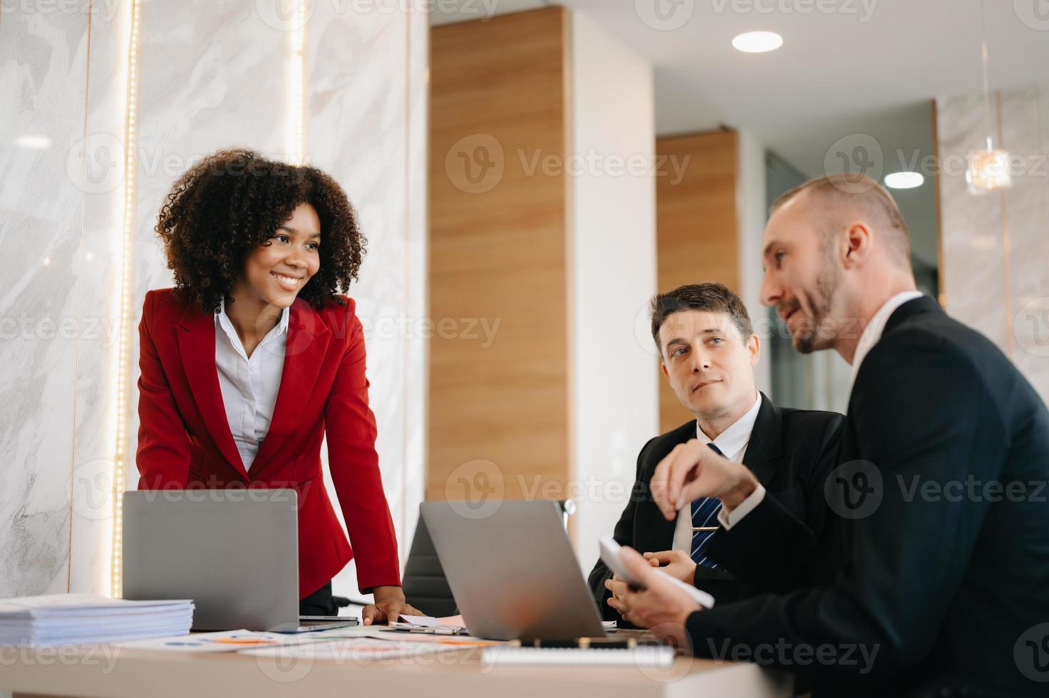 Happy businesspeople while collaborating on a new project in an office. Group of diverse businesspeople using a laptop and tablet in office. photo