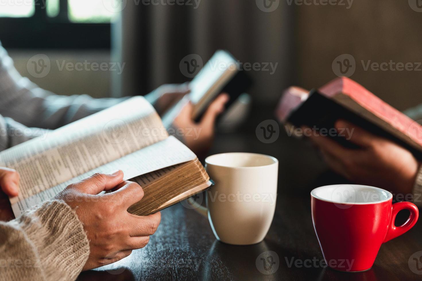 Small group of asian people praying worship believe. Teams of friends worship together before studying Holy bible. family praying together in church. Small group learning with prayer concept. photo