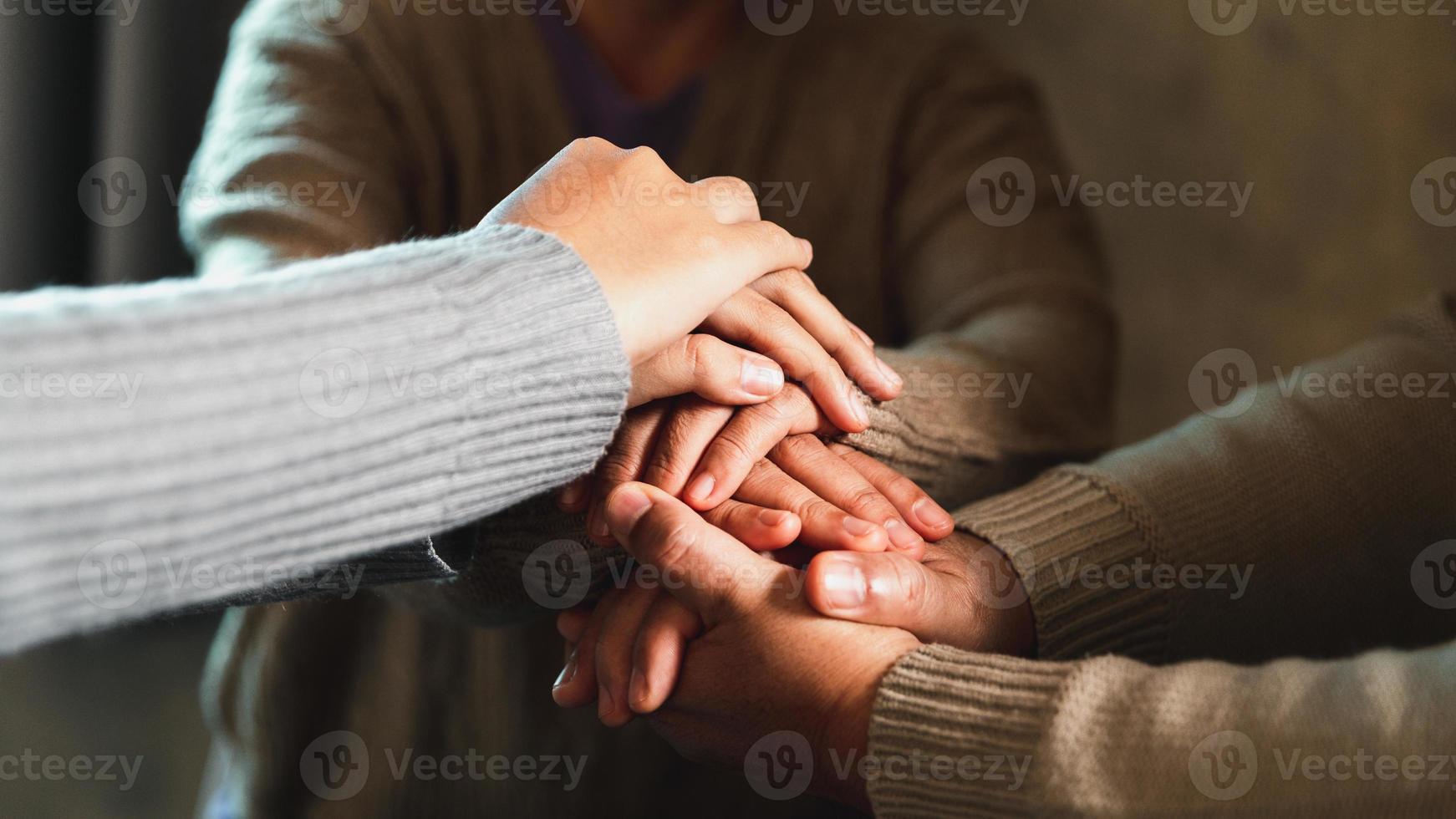 Small group of asian people praying worship believe. Teams of friends worship together before studying Holy bible. family praying together in church. Small group learning with prayer concept. photo