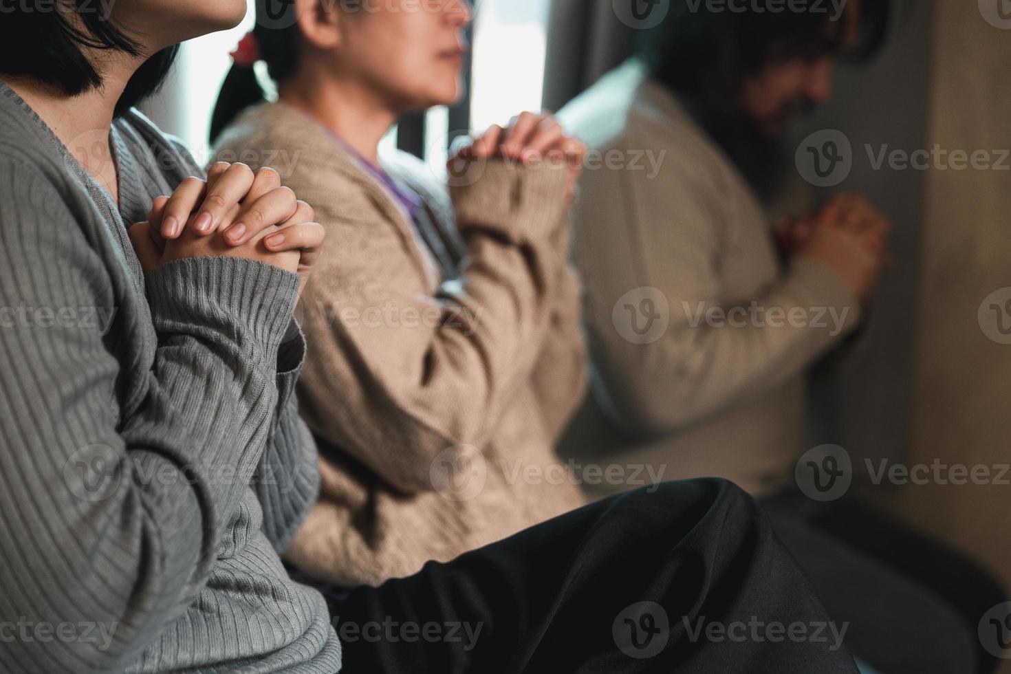 Small group of asian people praying worship believe. Teams of friends worship together before studying Holy bible. family praying together in church. Small group learning with prayer concept. photo