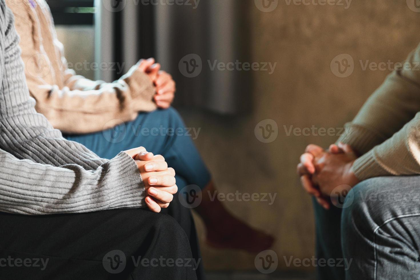 Small group of asian people praying worship believe. Teams of friends worship together before studying Holy bible. family praying together in church. Small group learning with prayer concept. photo