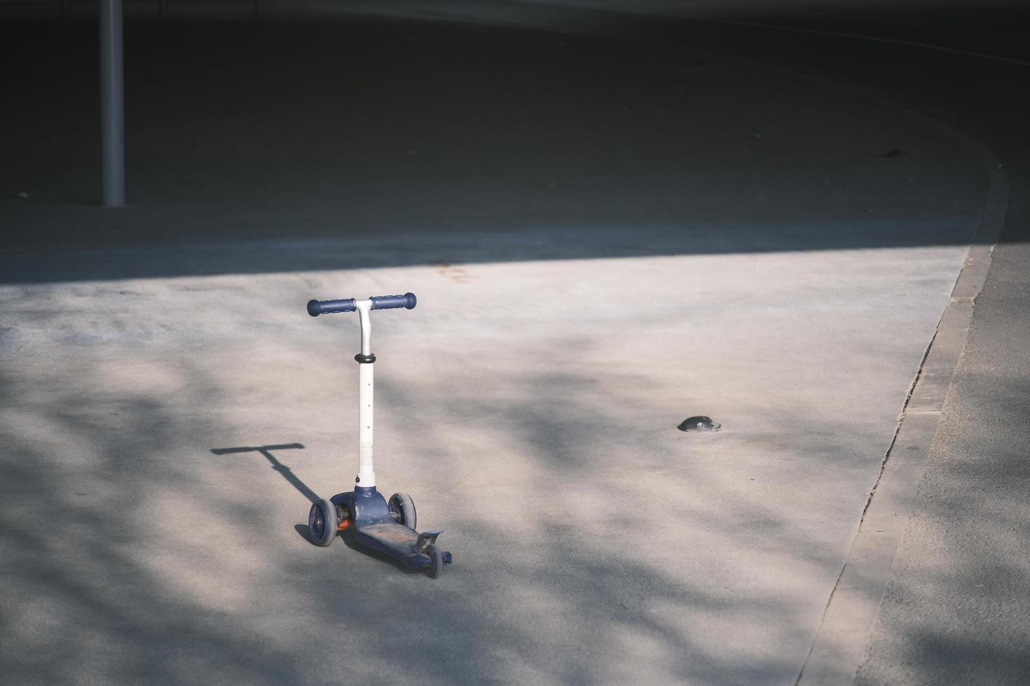 Lonely scooter on concrete floor photo