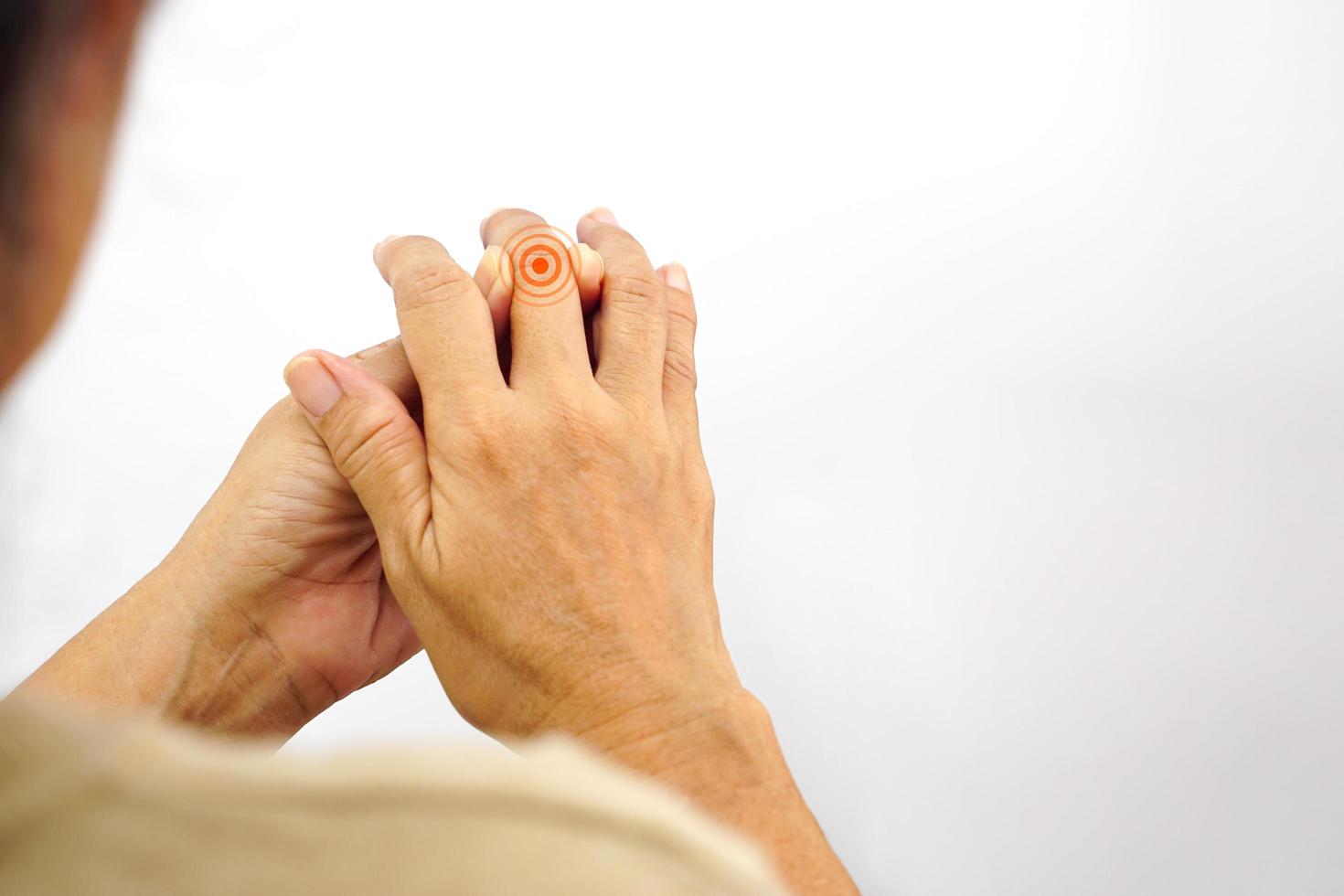 Focus of woman finger suffering from knuckle pain on white background. Healthcare and office syndrome concept. photo