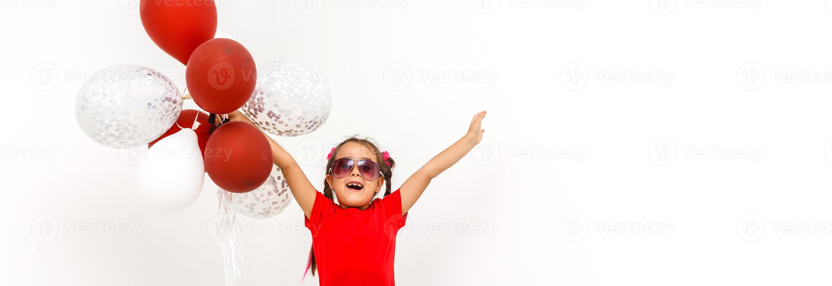 Little girl with balloons on a white background photo