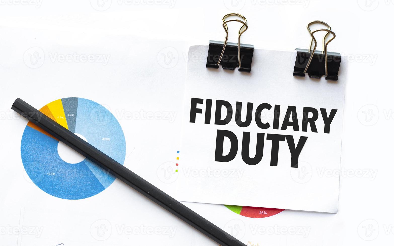 fiduciary duty on notebook with charts and pencil photo