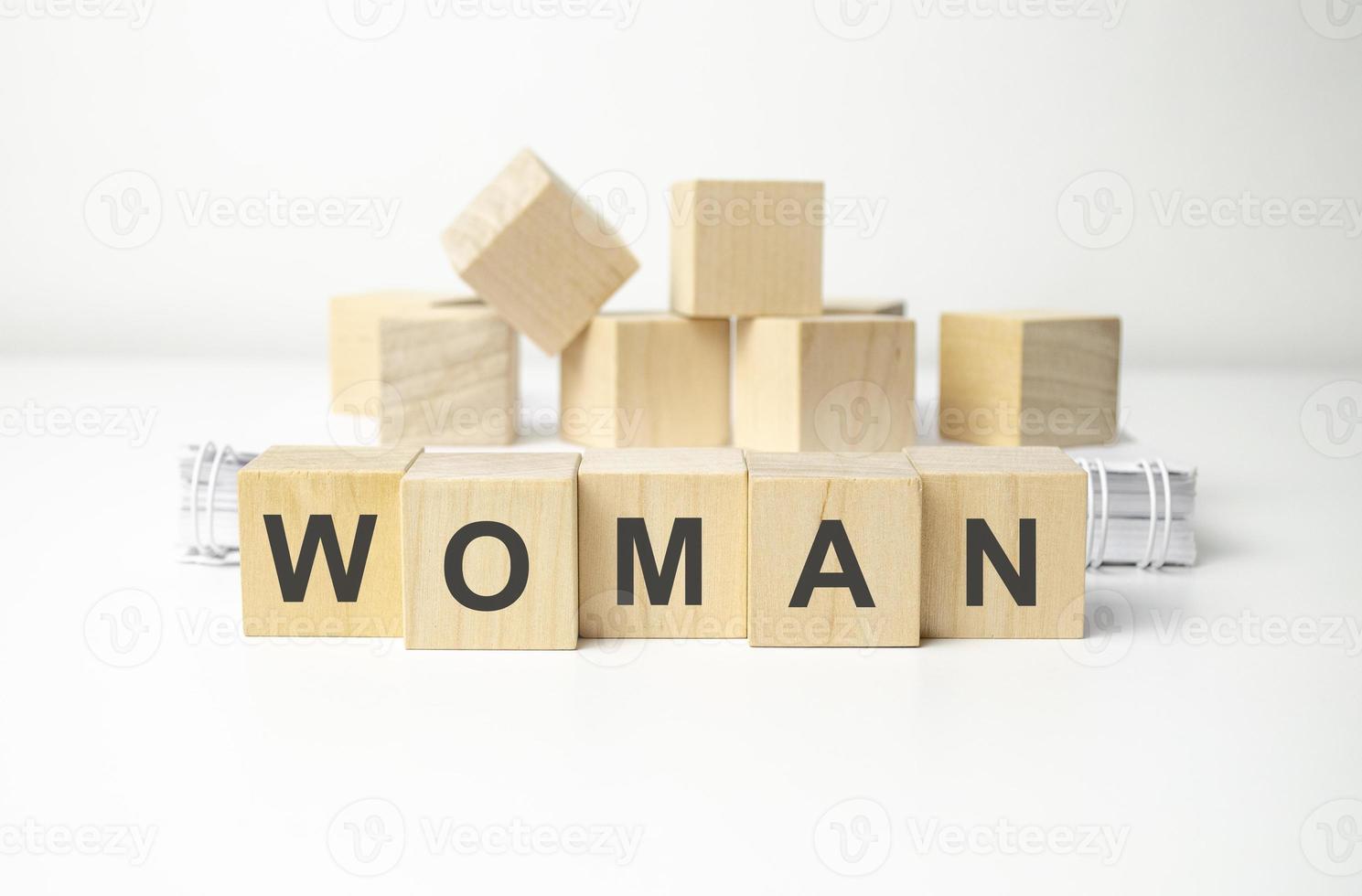 wooden cube block with woman business word on table background. photo