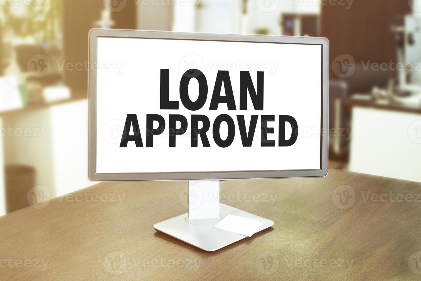 Monitor in modern office with text loan approved on the screen in the office photo