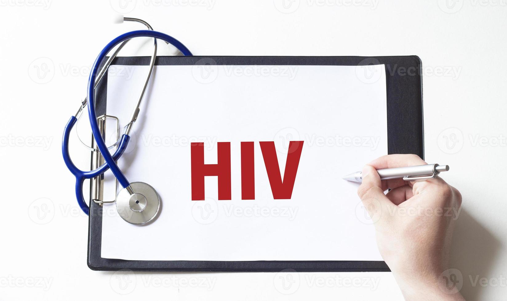 Doctor holding a pen and writting text hiv with pen, medical concept photo