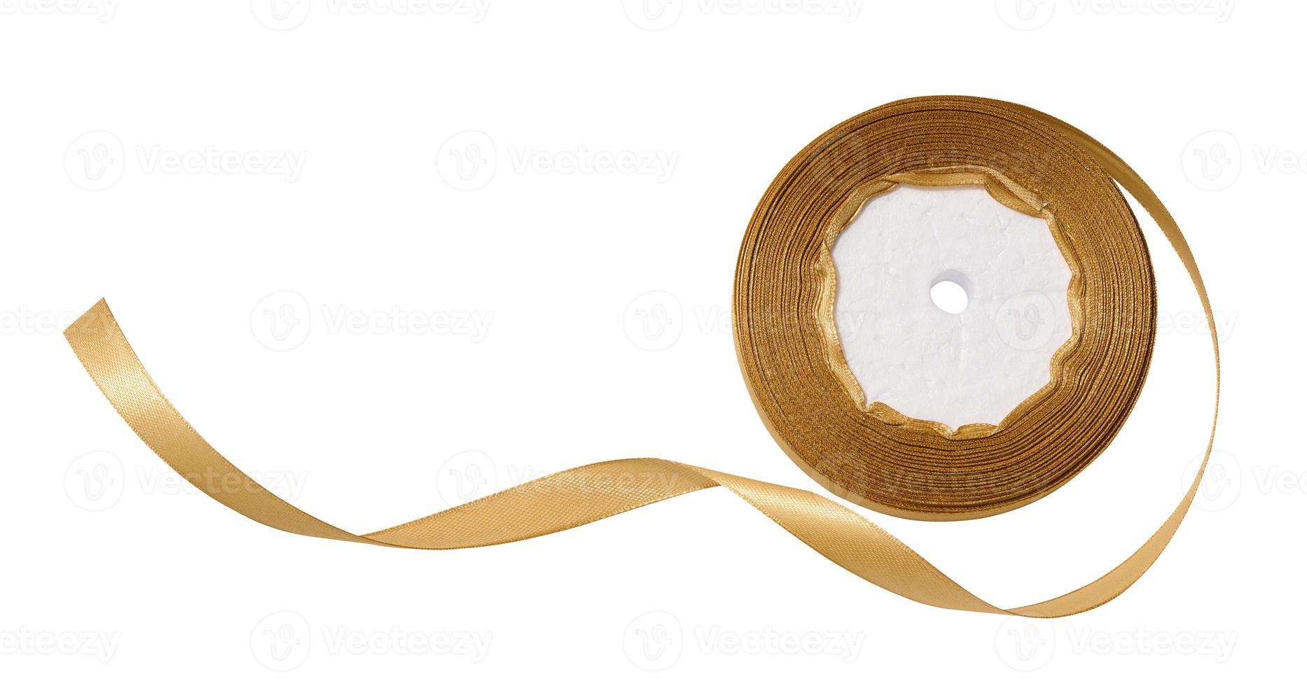 A spool with a golden silk ribbon on a white isolated background, an object for decoration photo