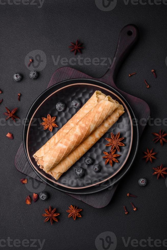 Delicious crispy wafer rolls with cream filling with nuts photo