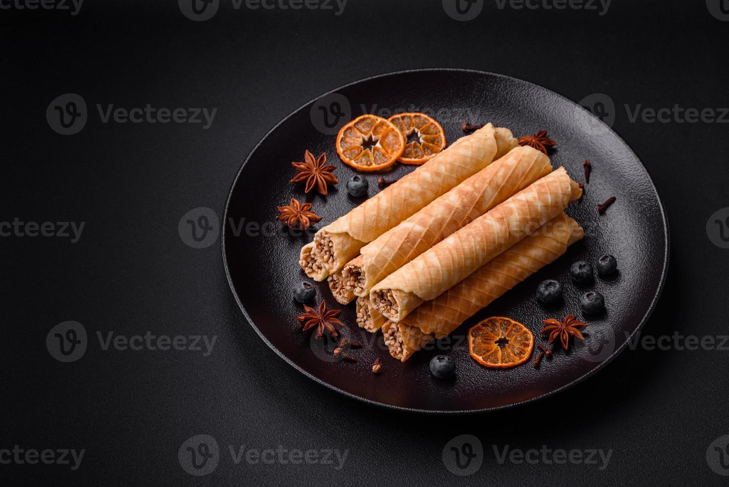 Delicious crispy wafer rolls with cream filling with nuts photo