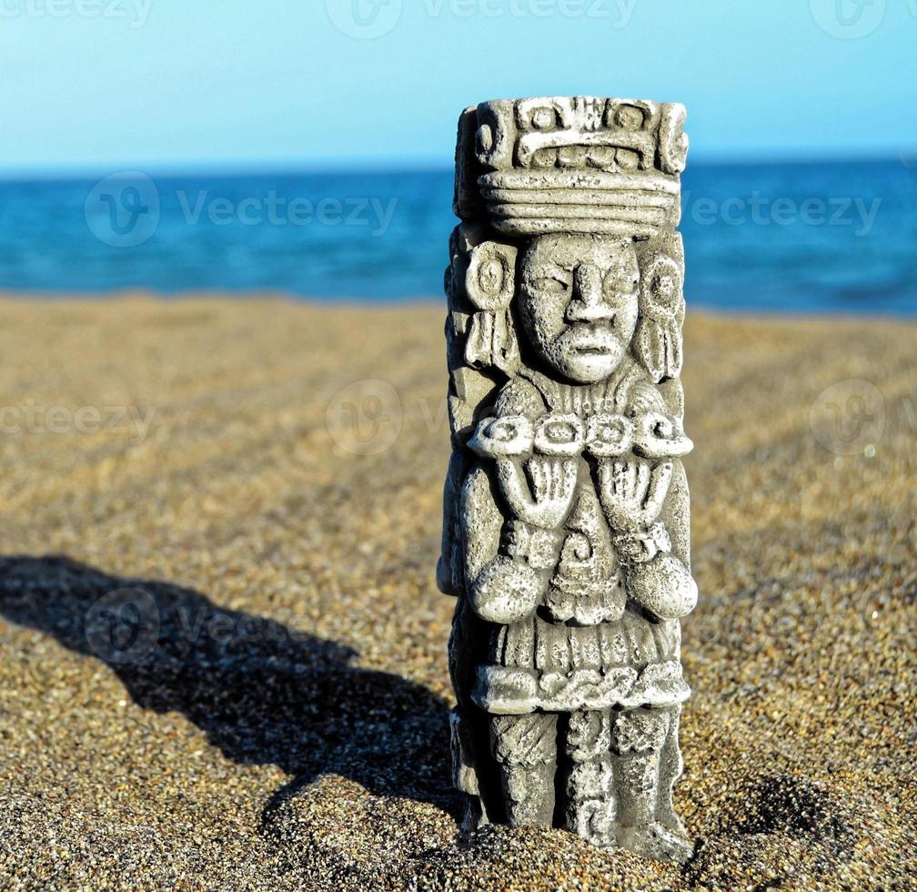 Small statue in the sand photo